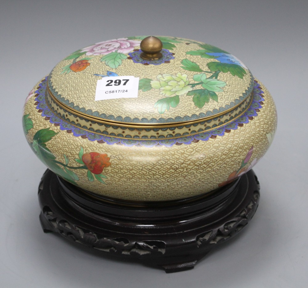 A Chinese cloisonne bowl and cover, decorated with flowers, on ebonised stand, diameter 26cm, overall height 21cm